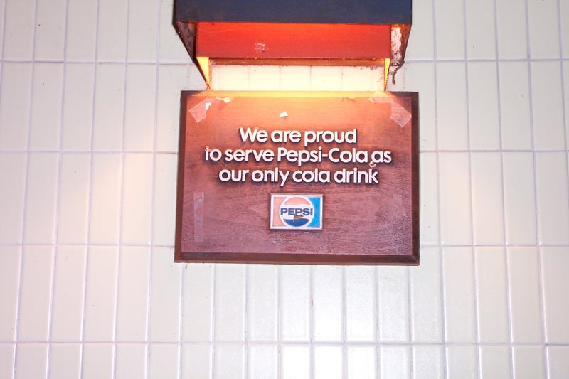 Sign on interior wall of snack bar.