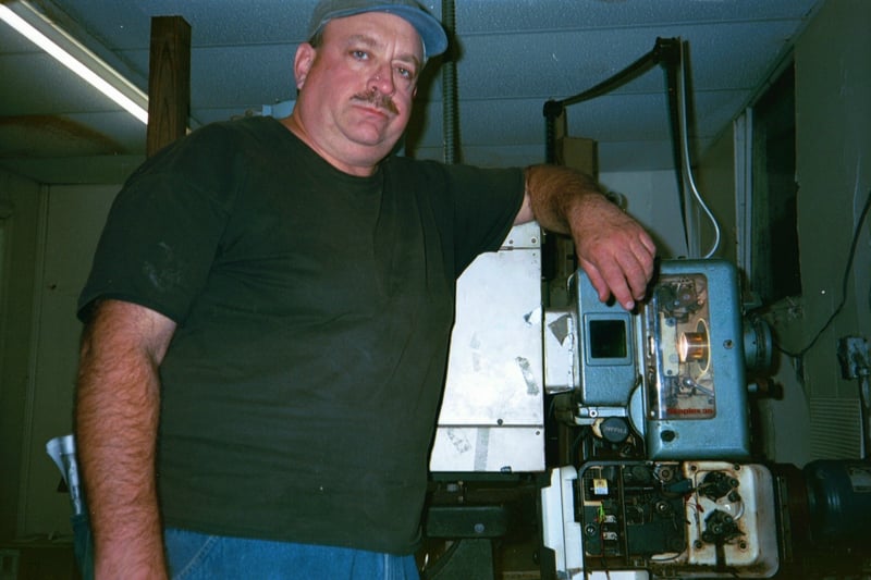 Troy Powell standing next to screen 3 projection.