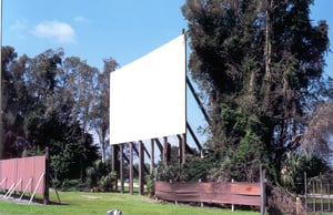 RUSKIN SCREEN. SITS HIGH UP ON LOG SUPPORTS. MADE GOOD VIEWING.