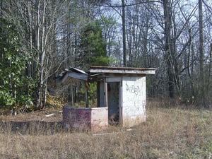 This is what is left of the ticket booth and entrance. You can see how the drive-in is all overgrown.