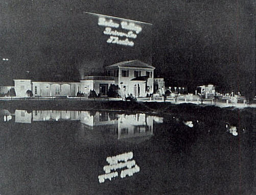 Cedar Valley screen tower at night with lake in foreground, from an old trade magazine