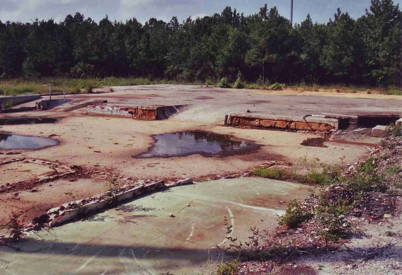 This picture shows the concrete foundation of the torn down garage which was built onto the slab of the former concession/projection building