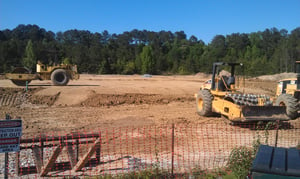 Drive-in being bulldozed to build a fire station.  You can still see the moon-light pole in the trees.