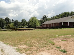 former site and concessionprojection building behind church