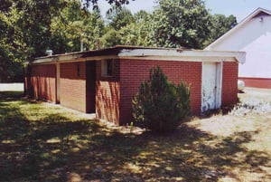 Back of concession building with church on the right