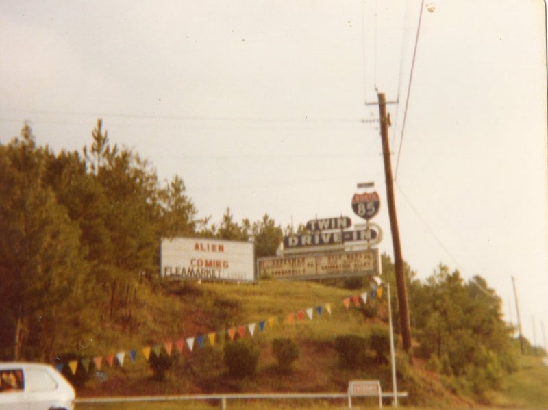 The entrance road and marquee at the North 85 Twin Drive-In from 1979.