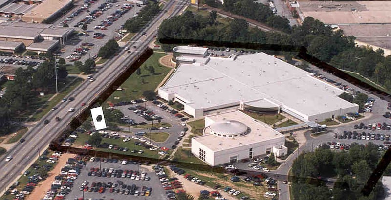 Aerial view of former Rexview site, now Columbus Technical College's north campus. Original property outlined in black, with former screen tower location indicated with black dot inside white marker. GA 85 is on left of photo; this view looks west.