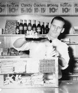 Herschel Gilbert pouring drinks in the concession of the Rexview.  Note the prices!