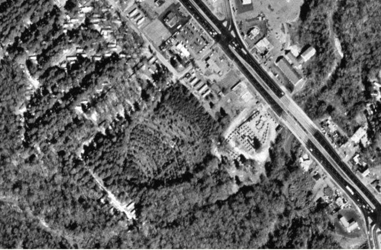 Parking rows can be still be discerned in this 1999 aerial view. Commercial buildings are between the former entrance to the drive-in and Victory Drive (US 27-280). This theater was popular with military personnel stationed at nearby Fort Benning. -- Chri