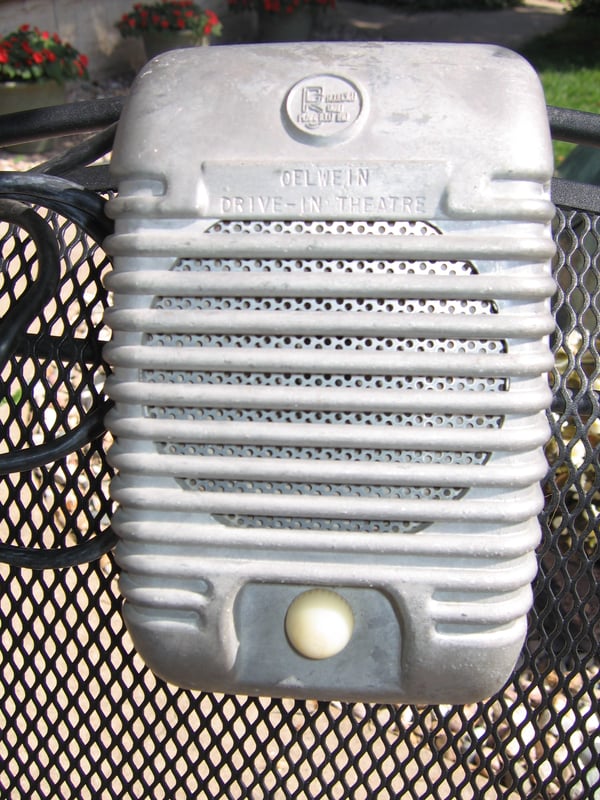 This is a drive-in speaker that is stamped OELWEIN DRIVE-IN THEATRE