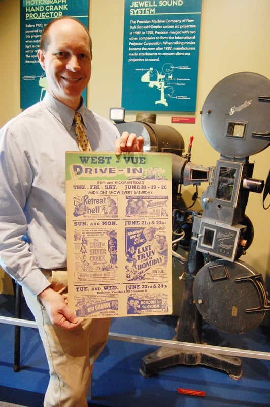 From article in magazine. Fan showing vintage poster.