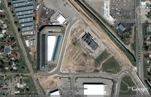 Aerial view of former drive-in site with screen visible on top left