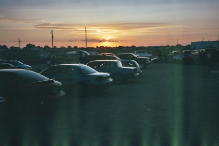 field with cars at sunset