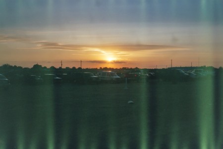 field with cars at sunset