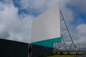 Side view of screen, fence, and sign on a beautiful day in Rexburg