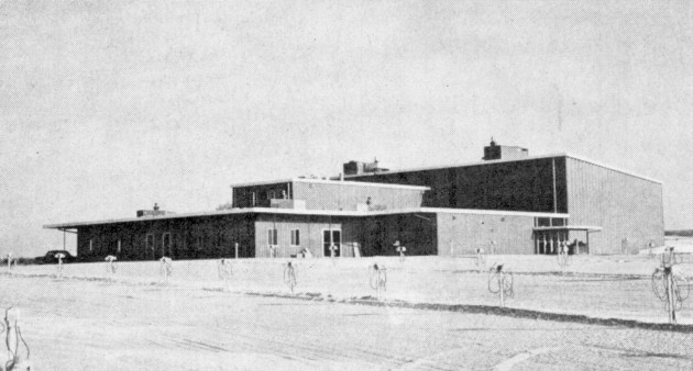 A front view of the unusual building: concessions with drive-in booth above, and the indoor theater behind.