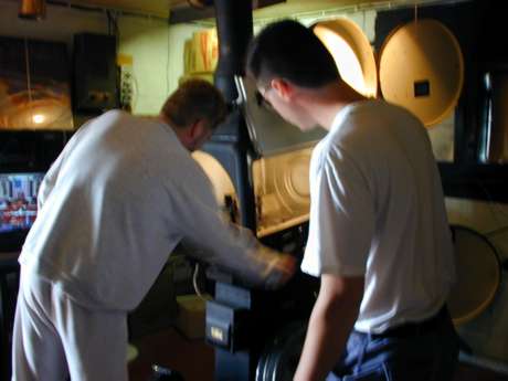 Owner Ron Magnoni shows Kipp the projector.