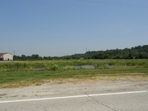 Just a small remnant of the entrance road remains