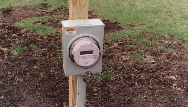 Electric meter beside Wind generators measures kilowatt-hours generated.  The meter read 2 KWH on March 15, 2009. It read 155 KWH on March 29.  Three nights of first movies shown for 2009 season, as indicated on marquee sign, used part of these 155 kwH fo