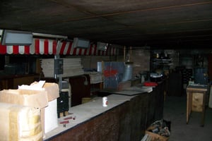 View of inside the old boarded up outdoor snackbar.
