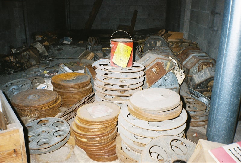 Rusting film cans and reels inside the screen tower.