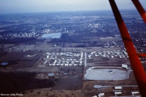 This photo was taken by my father while flying the plane. Our house was in the center of this photo. Current Google maps still show the ridges where the cars parked.submitted 6252012Alan Jolly