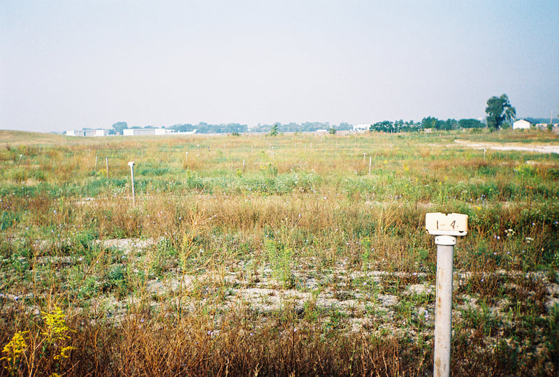 North field with speaker posts.  Airplane hangars are in the distance.