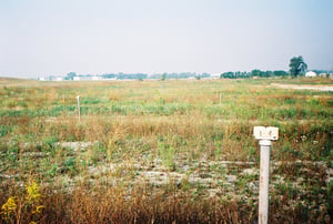 North field with speaker posts.  Airplane hangars are in the distance.