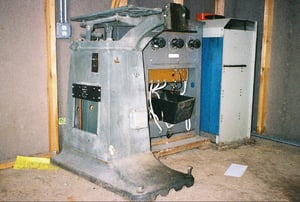 Old projector stand and electrical equipment sitting in a newer shed on the property.