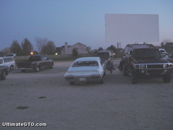 The owner of UltimateGTO.com is attending a movie on this good weather evening.  The white car is a 1968 Pontiac GTO.