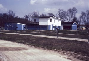 Deep blue concession building and projection booth with white portholes