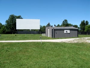 SCREEN AND PROJECTION BOOTH. SCREEN HAD FRESH COAT OF PAINT. GOOD THROW AND CLARITY. CAR HUMPS NOT WORN.