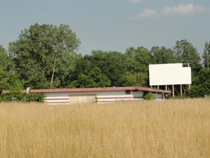 Second screen, overgrown field and concessionprojection building