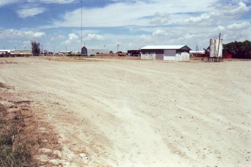 Dusty lot showing the concession building in the distance