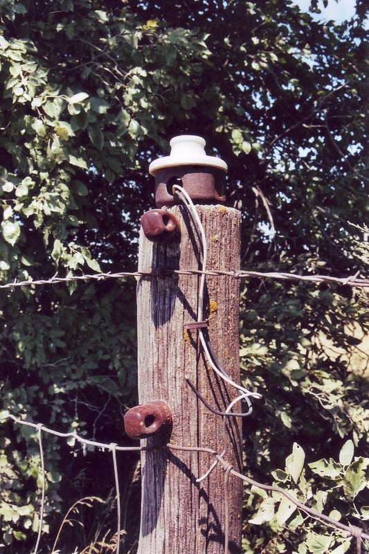 The light bulb sockets are still mounted to the wooden posts, but the cables have been cut