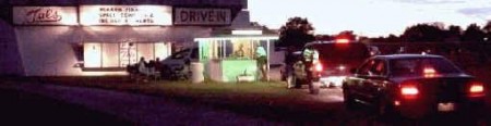 a rush of cars approaches Tal's Drive-In ticket booth at sunset, sure would be awesome if this ozoner was never demolished.....