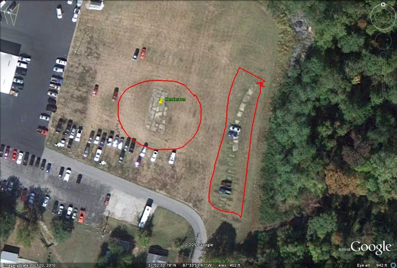 Google Earth image showing what looks like remains of screen base and projection booth foundation behind the car dealer