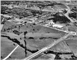 Shelbyville Road in Louisville with Shelbyville Road Plaza to the lower left and East Drive-in to the upper right. 4 lane Watterson Expressway is under construction.Mall St. Matthews will be built across from the drive-in.