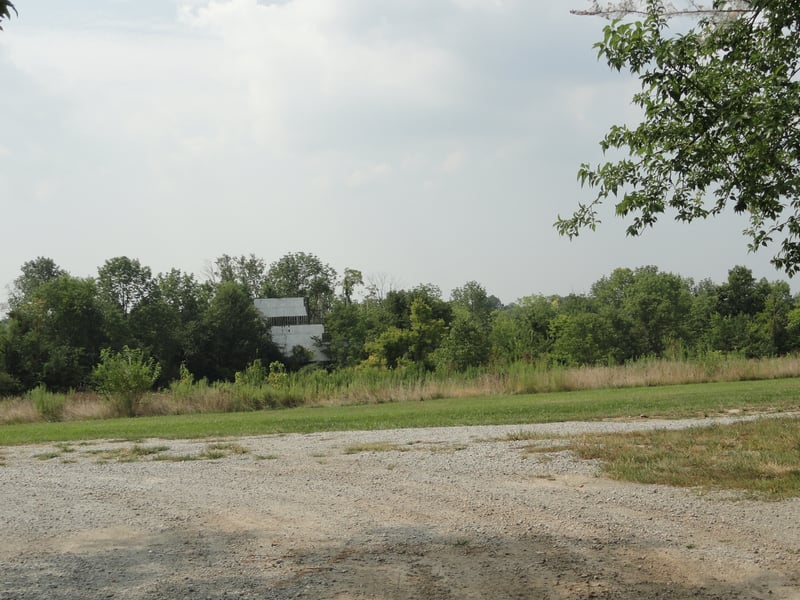 Looking down the hill over the field toward the screen