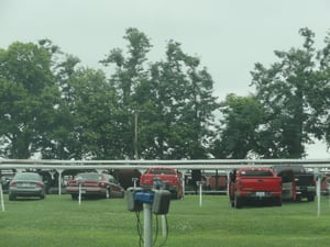 field with speakers and flea market in the back