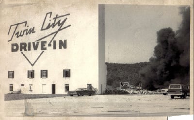 Tearing down the Twin City Drive-In in Horse Cave, Kentucky.  That's the concession stand burning down in the background.  Now a foam food container factory is in its place.