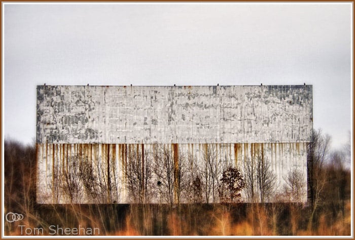 The screen of the abandoned Braintree Twin Drive-in in Braintree, Massachusetts. The grounds are now used for public commuter parking.