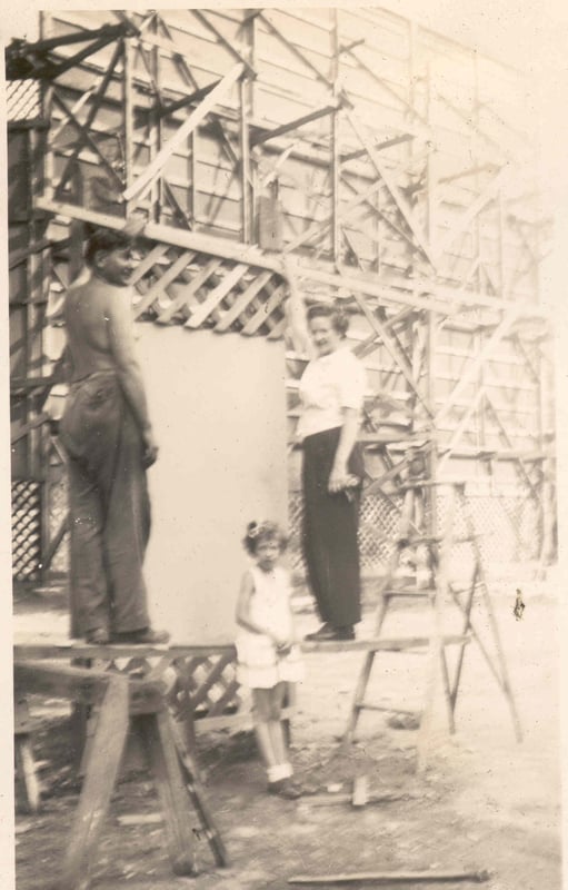 Charles, his wife Eleanor and daughter working on the original entrance billboard.  Note the wooden structure supporting the screen.
