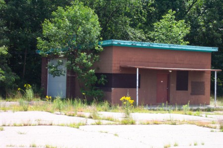 Side building to the left after entering the lot.  I believe this used to be a second snack bar.  Not used in years.  Note the garage door on the left side.