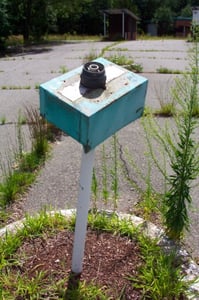 Old light fixture in the middle of the entrance road.