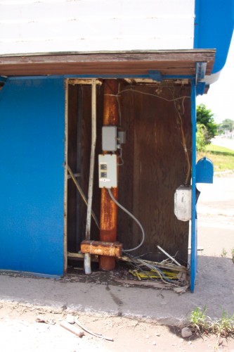 Lower interior of marquee. An access panel is missing or has been removed. Circuit breakers and a timer for the lights are visible.