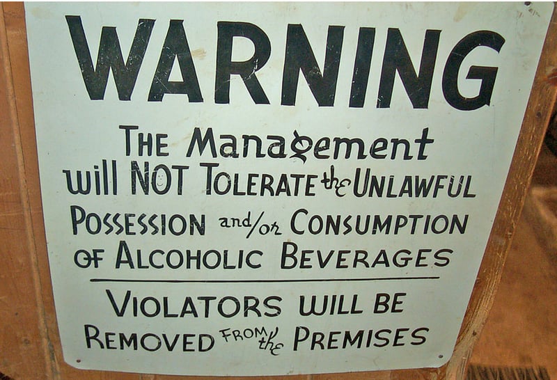 This warning sign to patrons used to be posted on the front of the old ticket booth at the entrance to the drive-in.