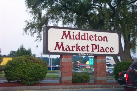 Sign for the shopping center that now occupies the site.  The sign lists the street address