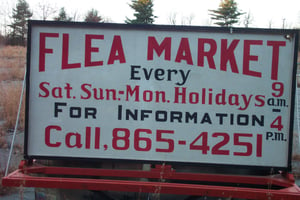 flea market sign mounted on trailer.