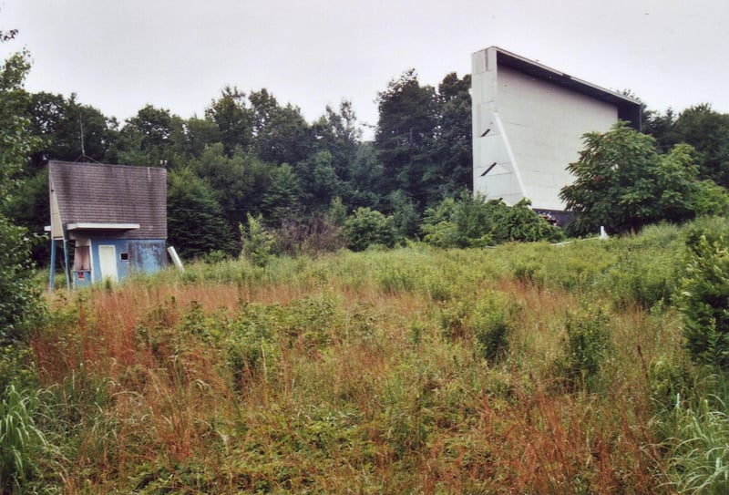 The screen and ticket booth waiting in the forest of better times